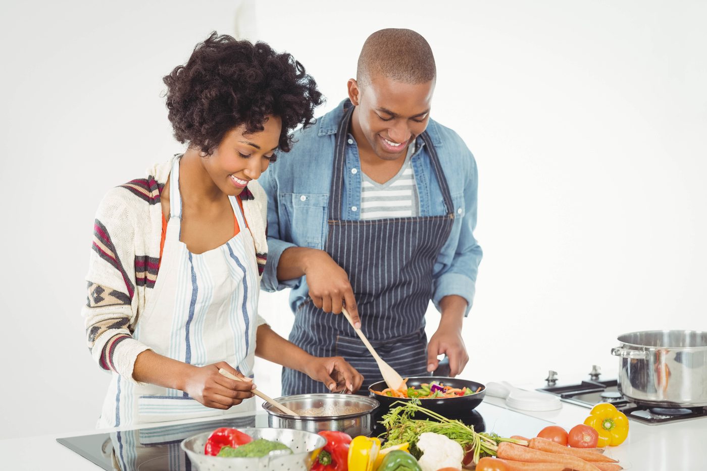 Happy couple cooking vegetables together