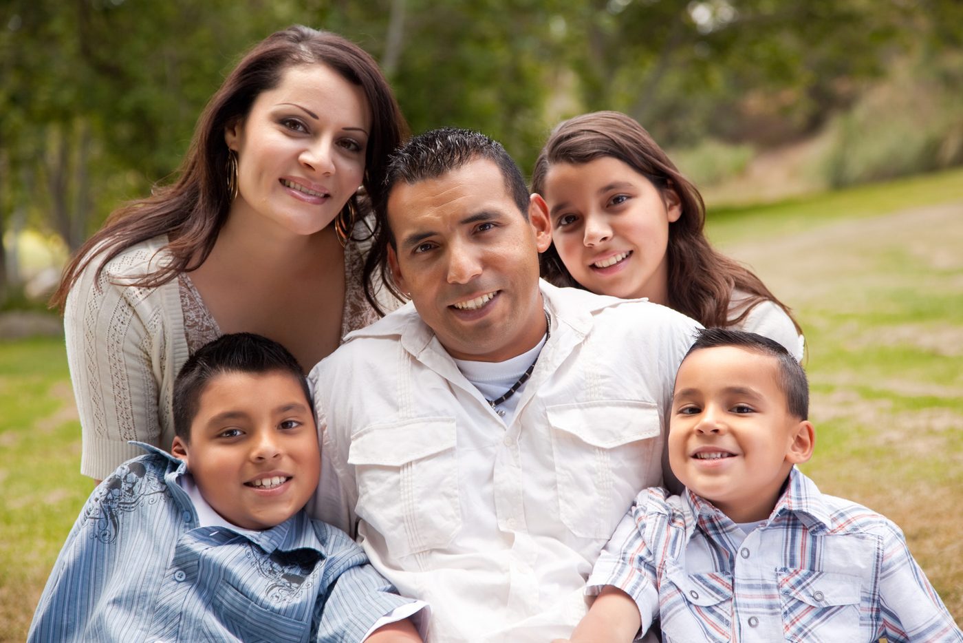 Happy Hispanic family portrait in the park